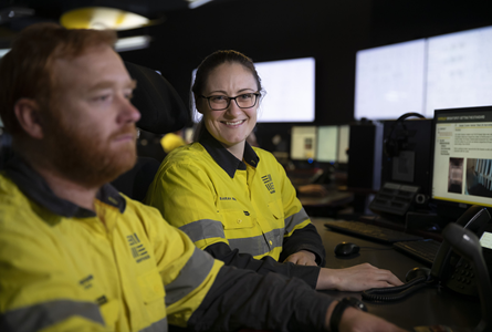 Two workers sitting near computers in a control room at Worsley