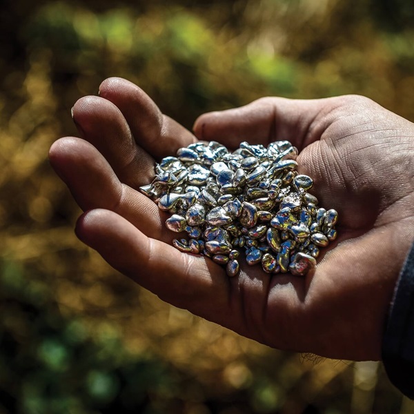 A hand holding silver